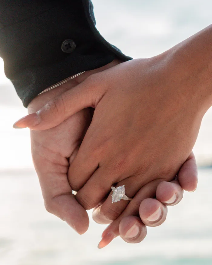 Sachin and Kierath holding hands, with the engagement ring